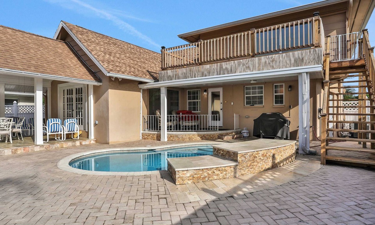 Harbor Hills House | Snowbird friendly elegant home with waterfront location pool grill fireplace
