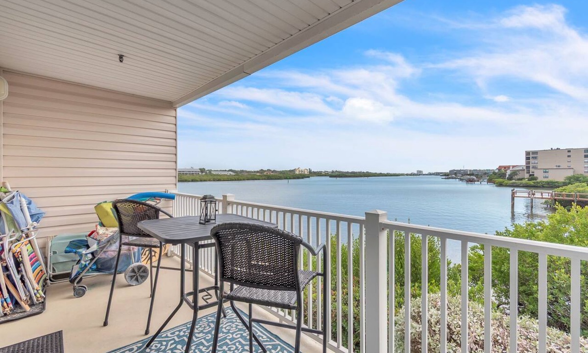 Indian Shores Condo | 🐬Water Views🐶Dogs Welcome🌞Walk to Beach🌴Heated Pool/Fishing Dock