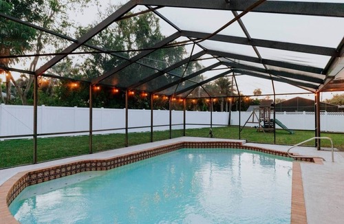Palma Sola House | COQUINA HAUS stylish home steps away from private Bay inlet!
