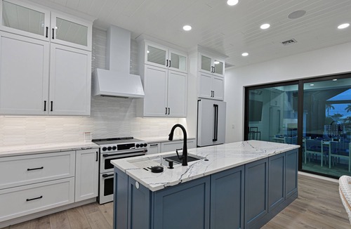 Whitney Beach House | Luxe Waterfront Canal Home w Heated Pool & Spa Rooftop Deck Outdoor Kitchen Golf