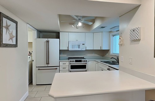Butler Beach Condo | Modern First-floor Condo with Pool, Porch, Beach Access.