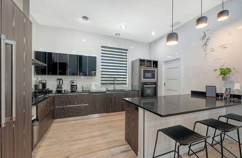Vamo House | Modern luxury retreat near Siesta Key with a heated saltwater pool, hot tub, private sports court, and cinema room. Fully furnished designer home with indoor-outdoor living, perfect for relaxing, entertaining, and enjoying the best of Sarasota.