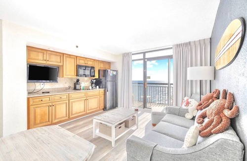 Windy Hill Condo | Oceanfront Condo Balcony with Resort Pool Hot Tub
