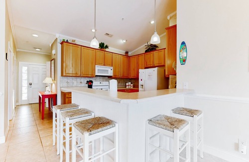 Sunset Beach Condo | SB61 Sunset Serenity: Sunny condo with a pool, balcony, kitchen, beach gear, W/D, & AC