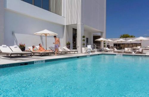 Seybold Hotel | Two Convenient Rooms with Large Glass Window and Outdoor Pool