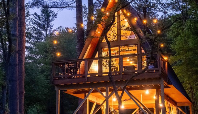 Designer A-Frame Treehouse with hot tub on river