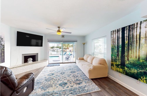 Capri Isle House | Renovated, waterfront townhome with pool & dock - walk to the beach